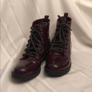 Patent leather combat boots.